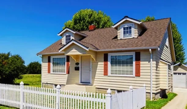 small-yellow-suburban-house-exterior-with-white-picket-fence (1)